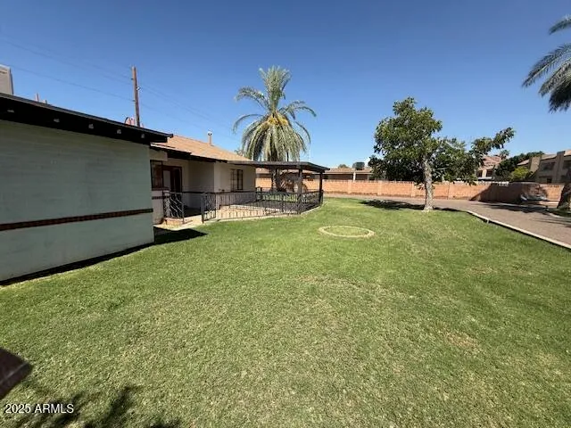 a view of a backyard with sitting area