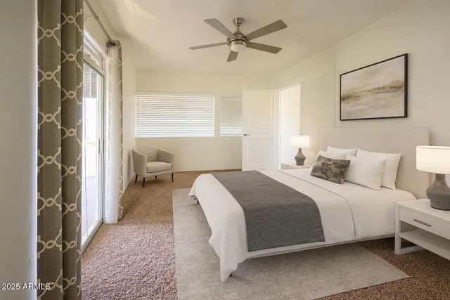 a spacious bedroom with a bed and a chandelier