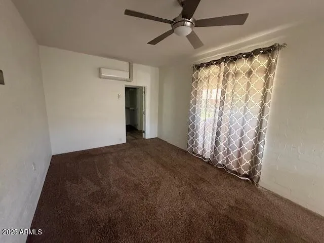 a view of empty room with ceiling fan