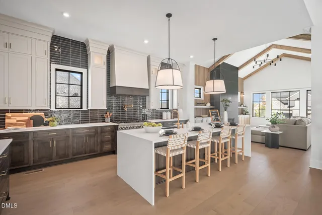 a large kitchen with a table and chairs