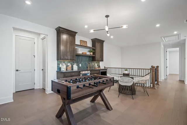 a dining room with furniture and wooden floor
