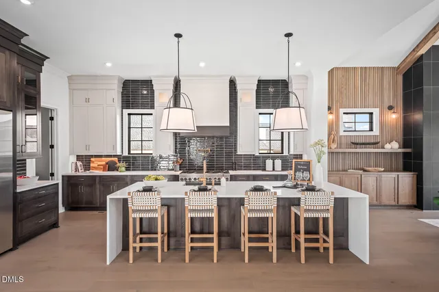 a large kitchen with a table and chairs