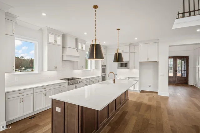 a kitchen with a sink refrigerator and microwave