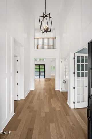 a view of a hallway with wooden floor and windows