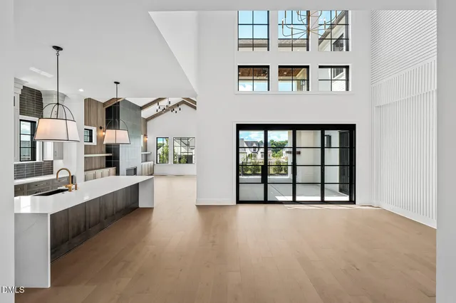 a view of an empty room with window and cabinet