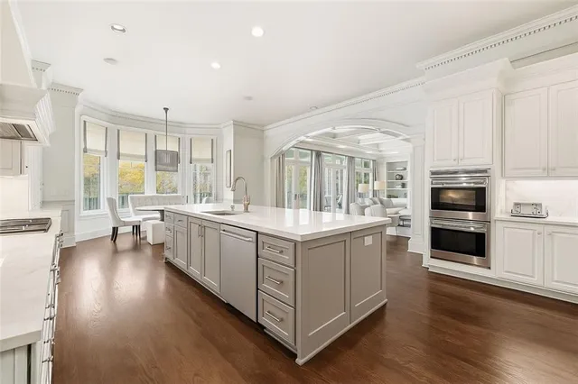 a dining room with furniture window and wooden floor