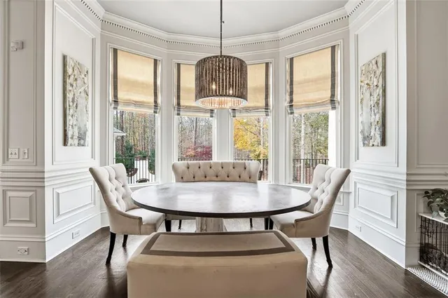 a living room with fireplace furniture and a large window