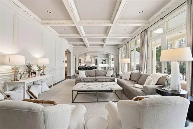 a living room with furniture a fireplace and a large window