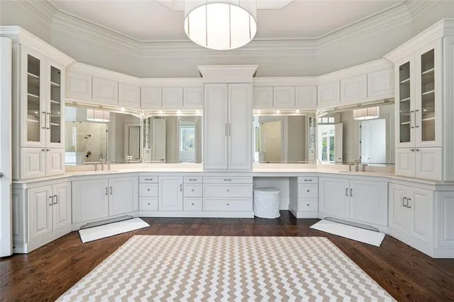 a bedroom with a bed and large windows