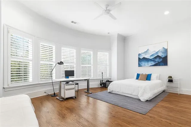 a bedroom with a bed and a painting on the wall