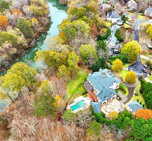 an aerial view of a house with swimming pool and garden