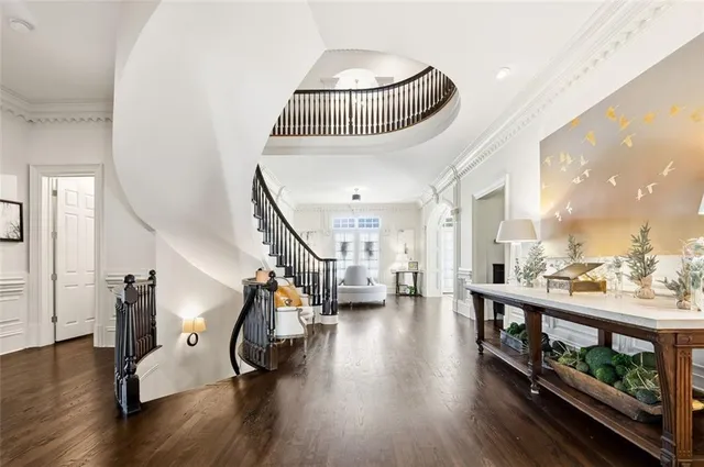 a view of a a dining room with furniture window and wooden floor