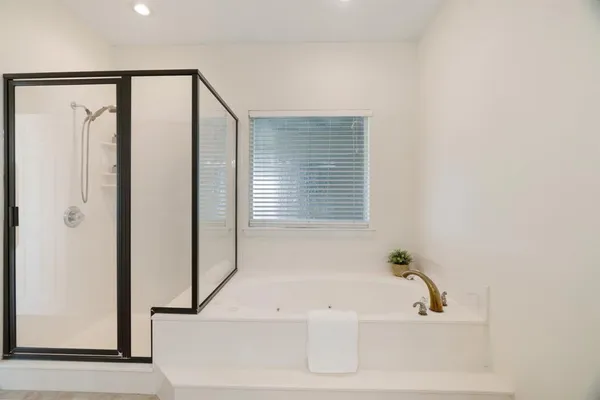 a bathroom with bathtub and shower