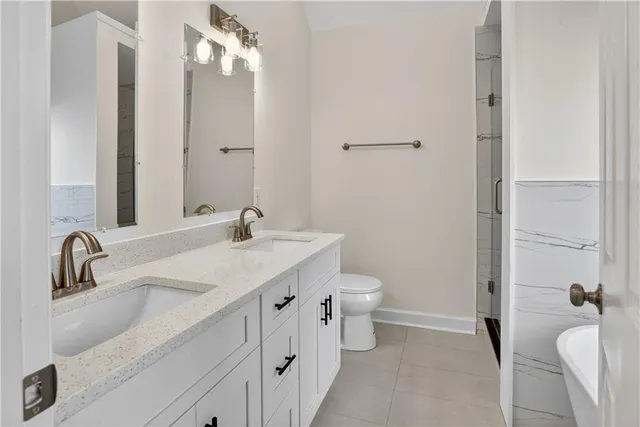 a bathroom with a sink and mirror with toilet
