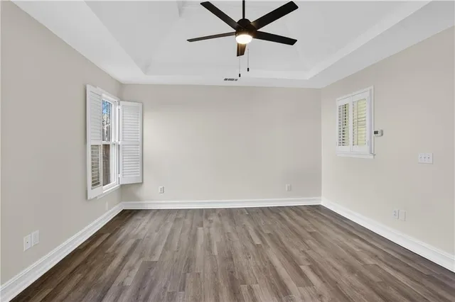 wooden floor in an empty room with a window