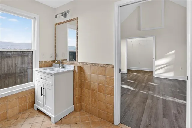 a bathroom with a sink mirror and shower