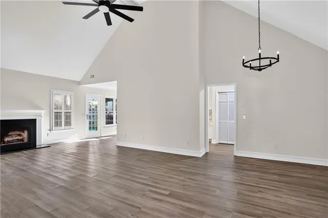 a view of empty room with a fireplace and wooden floor