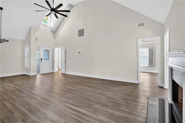 a view of a livingroom with wooden floor and a ceiling fan