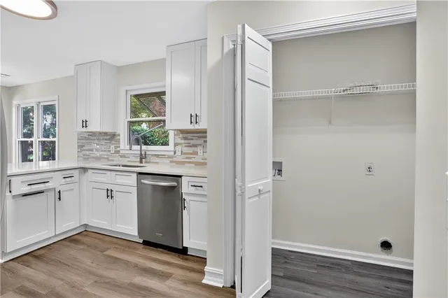 a kitchen with white cabinets and white appliances