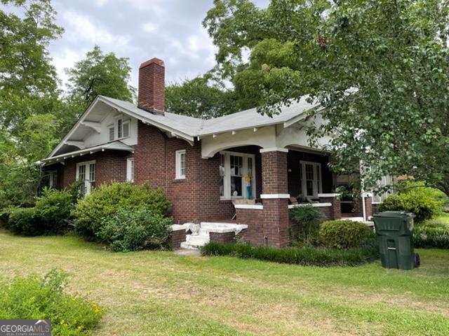 508 Main Street Collins, GA 30421 - Photo 1 of 1 a front view of a house with garden