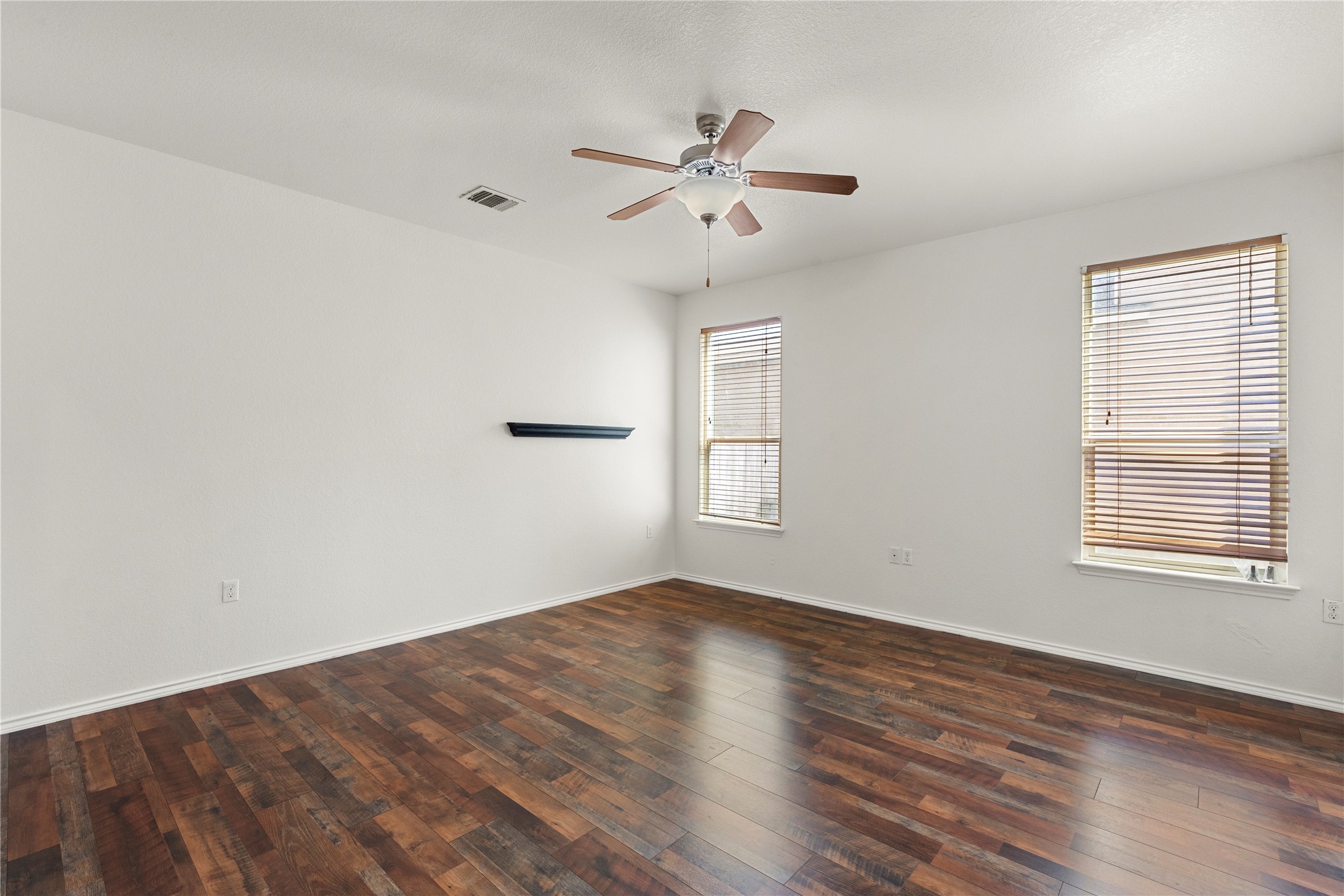 8613 Capitol View Drive Austin, TX 78747 - Photo 10 of 33 Rich hardwood-style flooring and abundant natural light define this versatile, spacious bedroom.