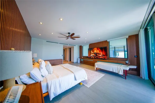 a bedroom with furniture and a flat screen tv