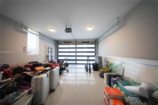 a gym room with lots of furniture and a chandelier