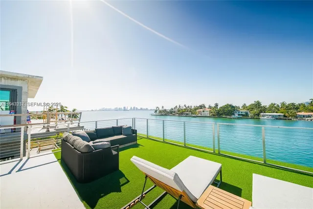 a view of a terrace with couches and city view