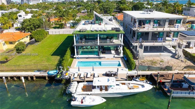 a aerial view of a house with swimming pool garden and patio
