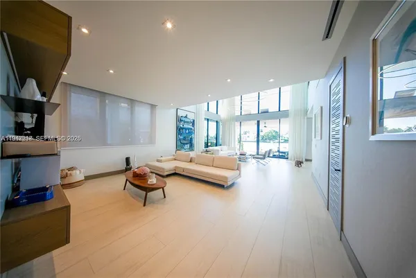 a living room with furniture and a large window