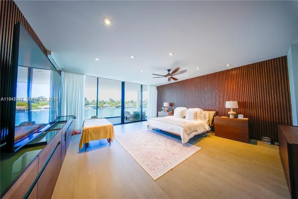 a bed room with furniture and a flat screen tv