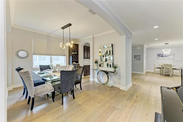 a large white kitchen with lots of counter space a sink and appliances