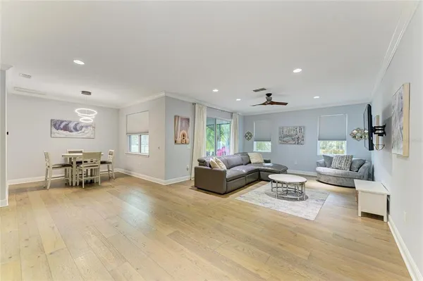 a view of a kitchen counter top space a sink wooden floor and a window