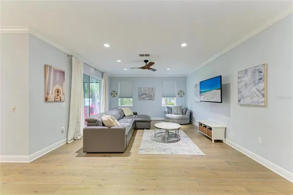 a living room with furniture and a wooden floor