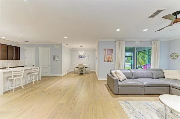 a view of a hallway with wooden floor and entryway