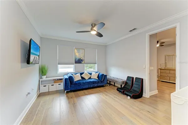 a living room with patio furniture and a floor to ceiling window