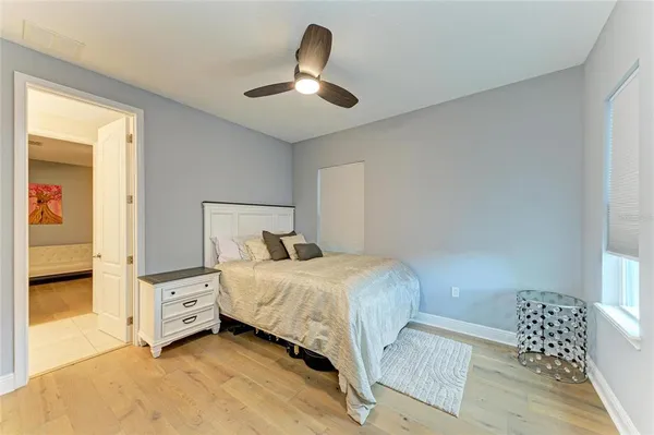 an aerial view of residential houses with outdoor space and trees