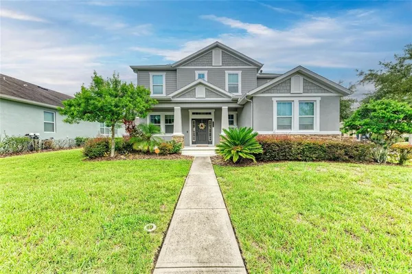 a view of a dining room with furniture and a chandelier