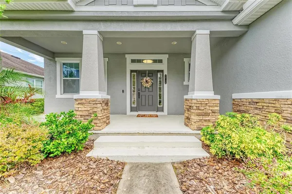 a view of a dining room with furniture a chandelier and wooden floor