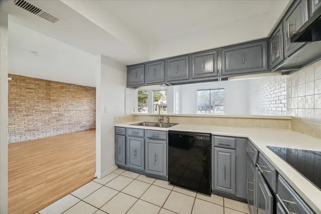 a kitchen with stainless steel appliances granite countertop a sink and cabinets