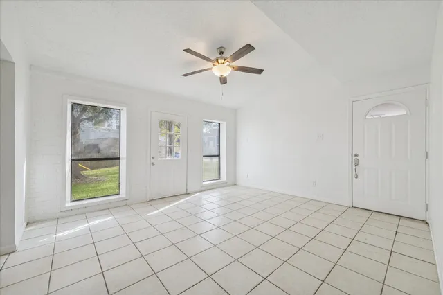 a view of an empty room with window and cabinet
