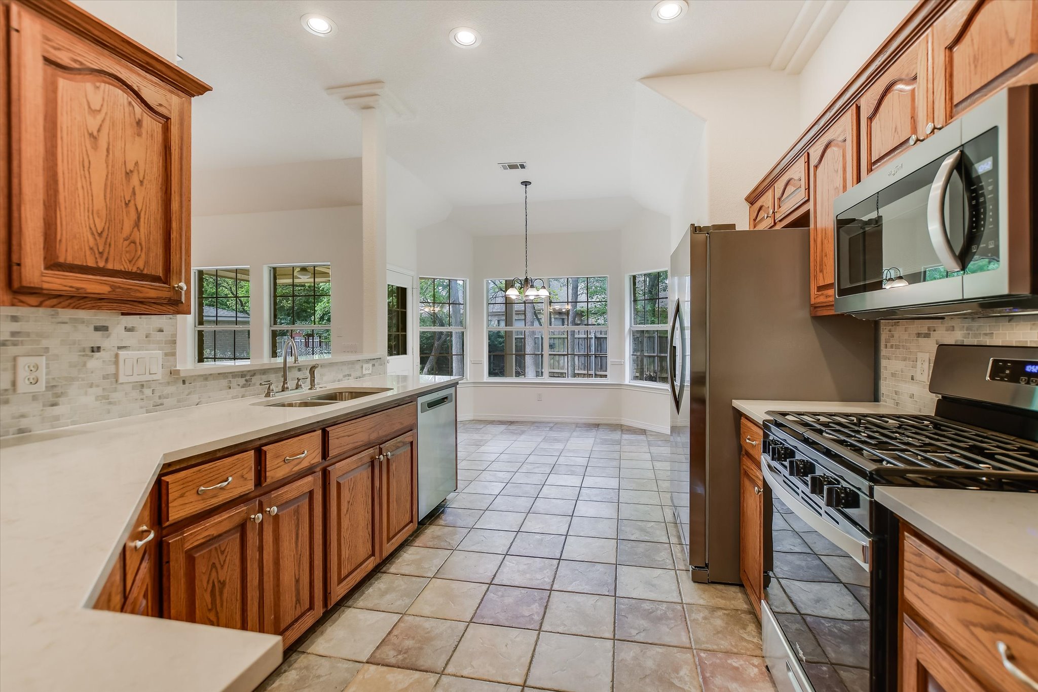 109 Stacey Cove Georgetown, TX 78628 - Photo 12 of 22 Kitchen area NEWLY upgraded with stainless steel appliances, countertops and backsplash which overlooks the breakfast area.