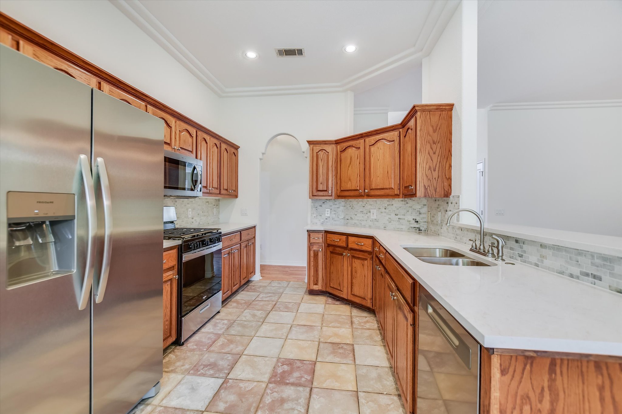 109 Stacey Cove Georgetown, TX 78628 - Photo 13 of 22 Kitchen area NEWLY upgraded with stainless steel appliances, countertops and backsplash which overlooks the living room area.