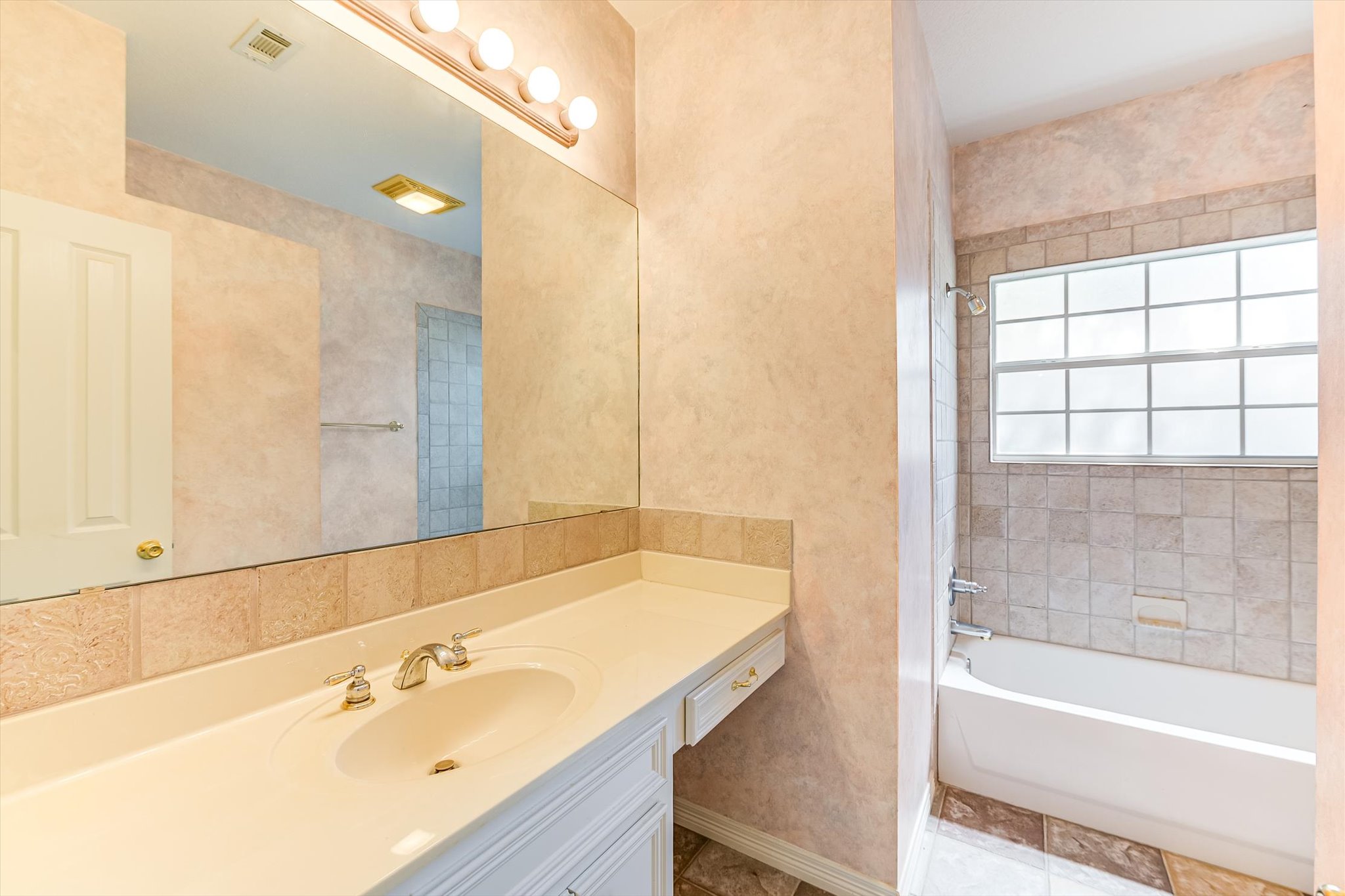 109 Stacey Cove Georgetown, TX 78628 - Photo 19 of 22 Second bathroom with bathing tub / shower combination and vanity.