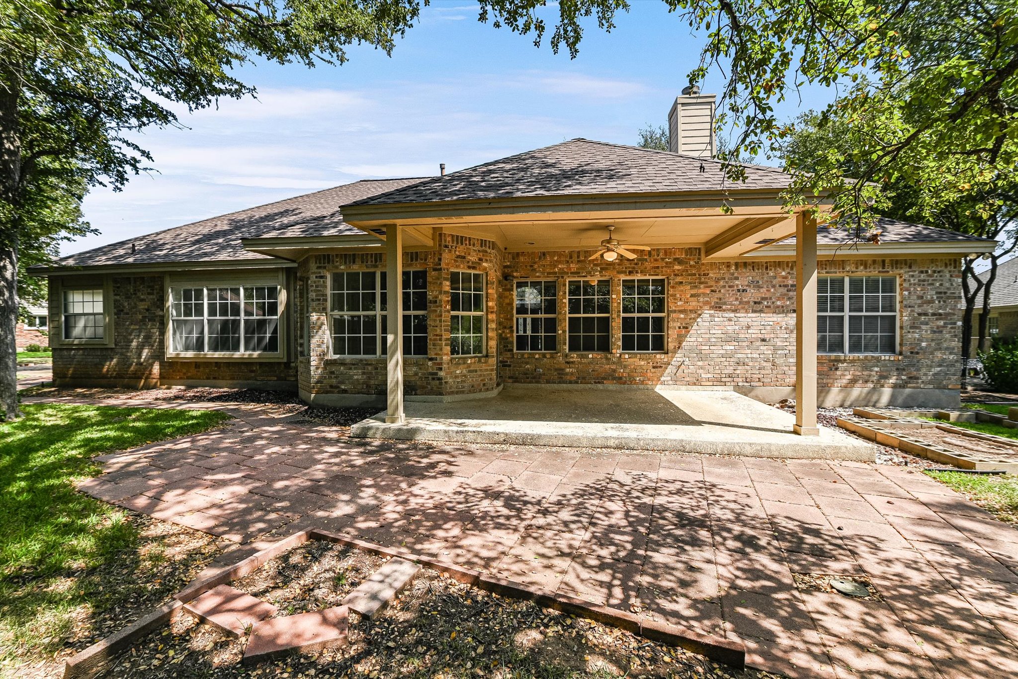 109 Stacey Cove Georgetown, TX 78628 - Photo 21 of 22 Covered backyard patio, brick siding, and a ceiling fan.