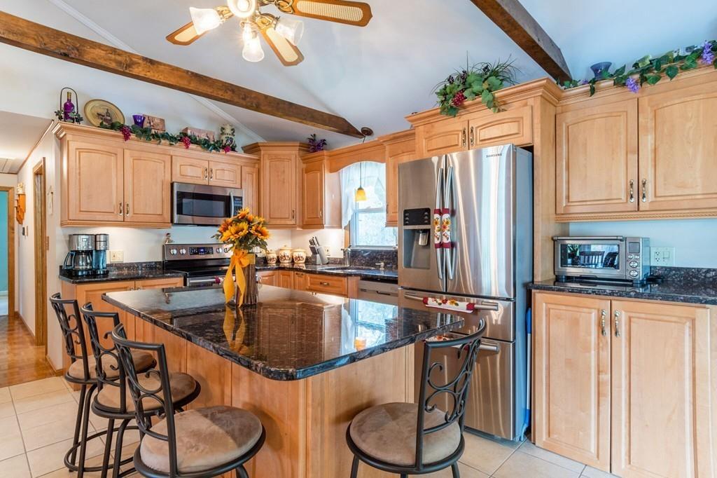 2 Old County Road Pelham, NH 03076 - Photo 3 of 38 a kitchen with stainless steel appliances granite countertop a sink a stove and a refrigerator
