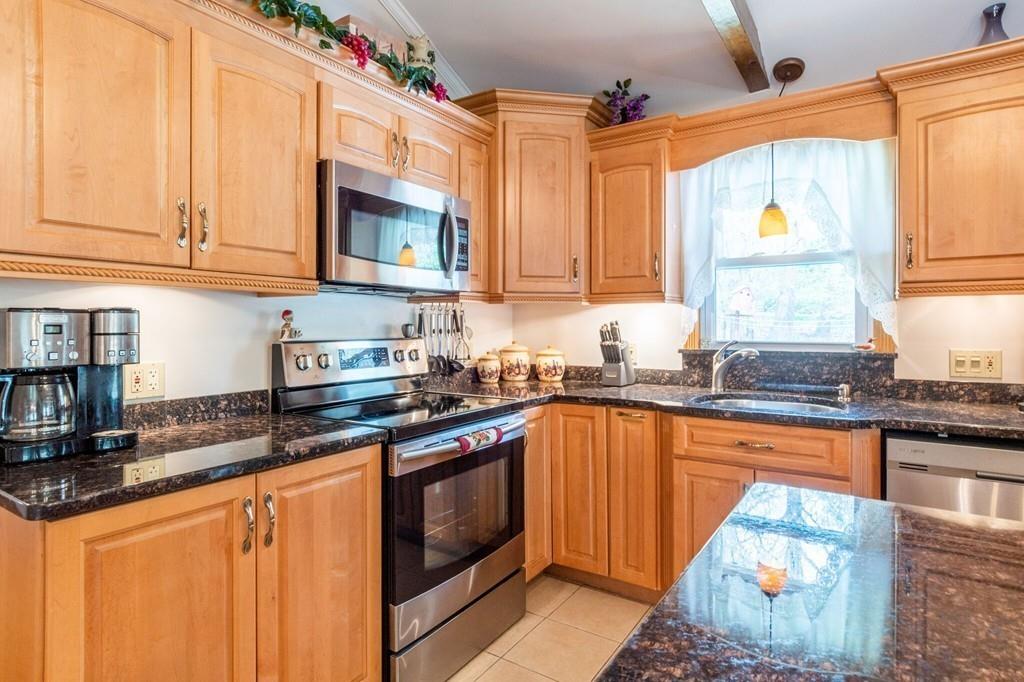 2 Old County Road Pelham, NH 03076 - Photo 5 of 38 a kitchen with stainless steel appliances granite countertop a stove a sink and a microwave