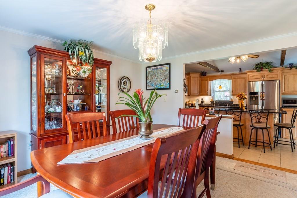 2 Old County Road Pelham, NH 03076 - Photo 8 of 38 a living room with furniture a chandelier and a dining table