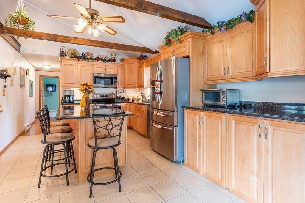 2 Old County Road Pelham, NH 03076 - Photo 9 of 38 a kitchen with stainless steel appliances granite countertop a refrigerator and microwave