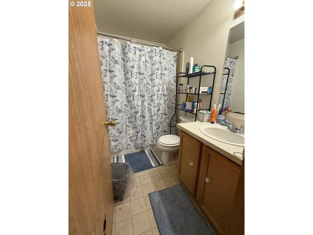 a view of a balcony with wooden floor and fence